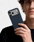Man holding steel blue aramid fiber magnetic phone case showing premium texture