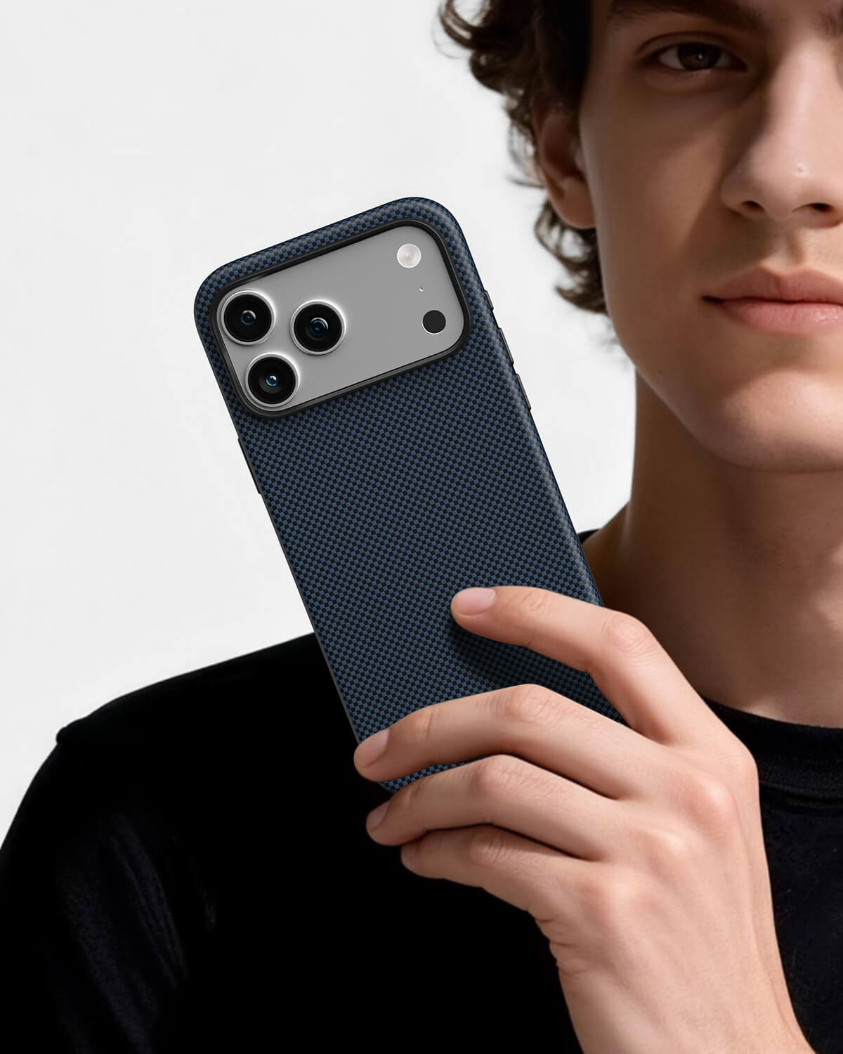 Man holding steel blue aramid fiber magnetic phone case showing premium texture