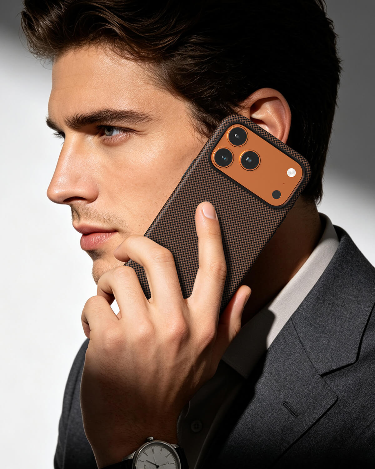 Businessman making phone call using brown checkered aramid fiber case